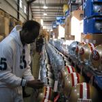 Jerry Rice autographing 49er and Raider helmets for National Sports Distributors