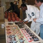 Jerry Rice autographing photos for National Sports Distributors
