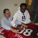 Jerry Rice autographing jerseys for National Sports Distributors