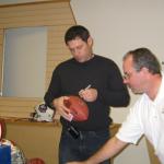 Steve Young autographing footballs for National Sports Distributors