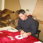 Steve Young autographing jerseys for National Sports Distributors