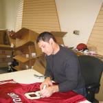 Steve Young signing jerseys for National Sports Distributors