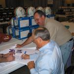 Nolan Ryan autographing jerseys for National Sports Distributors