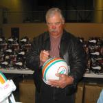 Larry Csonka autographing helmets for National Sports Distributors