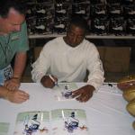 Cris Carter autographing 8x10 photos for National Sports Distributors