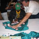 Ricky Williams autographing jerseys for National Sports Distributors