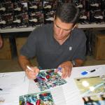 Trent Green autographing photos for National Sports Distributors