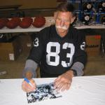 Ben Davidson autographing 8x10 photos for National Sports Distributors