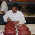 Dwight Clark autographing footballs at National Sports Distributors