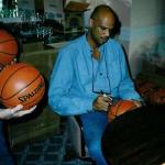 Kareem Abdul Jabbar autographing basketballs for National Sports Distributors