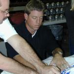 Troy Aikman autographing jerseys for National Sports Distributors