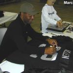 Marcus Allen autographing jerseys for National Sports Distributors