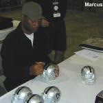 Marcus Allen autographing mini helmets for National Sports Distributors