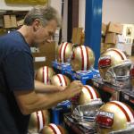 Joe Montana signing helmets for National Sports Distributors