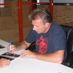 Joe Montana autographing photos for National Sports Distributors