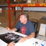 Joe Montana autographing 16x20 photos for National Sports Distributors