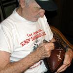 Sammy Baugh autographing Throwback Duke Footballs for National Sports Distributors