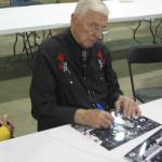 Chuck Bednarik signing photos for National Sports Distributors