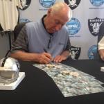 Fred Biletnikoff autographing photos for NSD