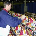 Brad Johnson autographing helmets for National Sports Distributors