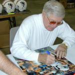 George Blanda autographing photos for National Sports Distributors