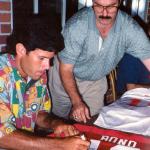 Steve Bono autographing jerseys for National Sports Distributors