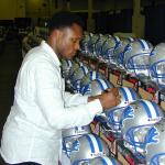 Barry Sanders autographing helmets for National Sports Distributors