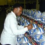 Barry Sanders autographing helmets for National Sports Distributors