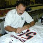 Dick Butkus autographing jerseys for National Sports Distributors