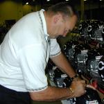 Disck Butkus autographing helmets for National Sports Distributors