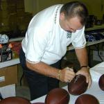 Dick Butkus autographing Throwback Duke Footballs for National Sports Distributors