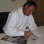 Dwight Clark autographing photos at National Sports Distributors