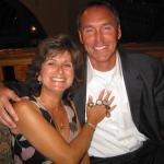 Dwight Clark and Joan Hemphill admiring his 5 Super Bowl rings at appearance dinner