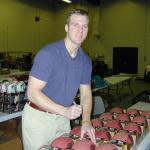 Tim Couch autographing footballs for National Sports Distributors