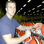 Tim Couch autographing helmets for National Sports Distributors