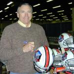 Dave Wilcox autographing helmets for National Sports Distributors