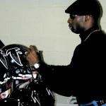 Deion Sanders autographing Falcon helmets for National Sports Distributors