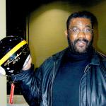 Joe Greene showing off an autographed Steel Curtain Pro Line Helmet