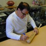 Pete Rose autographing bats for National Sports Distributors