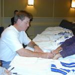 Troy Aikman autographs authentic jerseys for National Sports Distributors