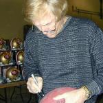 Fran Tarkenton autographing footballs for National Sports Distributors