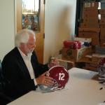 Ken Stabler signing helmets for National Sports Distributors