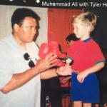 Muhammad Ali "boxing" with owner's son