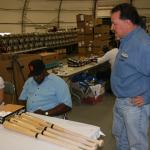 Willie McCovey autographing bats for National Sports Distributors