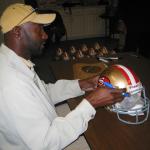 Jerry Rice autographing helmets for National Sports Distributors