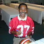 Jimmy Johnson autographing helmets for National Sports Distributors