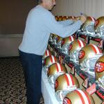 Joe Montana autographing helmets for National Sports Distributors