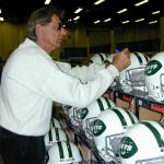 Joe Namath autographing helmets for National Sports Distributors