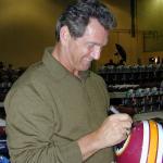 Joe Theismann autographing helmets for National Sports Distributors