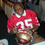 John Henry Johnson autographing helmets for National Sports Distributors